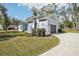 The beautifully landscaped single-Gathering home features blue siding and an attached garage at 475 W Main St, Lake Helen, FL 32744