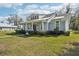 Charming single-Gathering home features a lush green lawn and beautifully manicured landscaping at 475 W Main St, Lake Helen, FL 32744