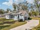 Beautiful exterior view with a long driveway, lush lawn, and attached garage at 475 W Main St, Lake Helen, FL 32744