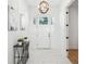 Bright foyer featuring tiled floors, modern lighting fixture, and stylish decor at 475 W Main St, Lake Helen, FL 32744