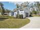 Gray house with a two-car garage and landscaped yard at 475 W Main St, Lake Helen, FL 32744