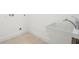 Bright laundry room with utility sink and tile floor at 475 W Main St, Lake Helen, FL 32744