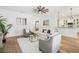 Cozy living room with wood floors, ample seating, and a view into the modern kitchen at 475 W Main St, Lake Helen, FL 32744
