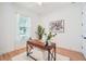 Home office features a desk, white rug, and a window providing natural light for a comfortable workspace at 475 W Main St, Lake Helen, FL 32744