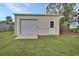 Exterior view of a storage shed featuring a roll-up door and entry door at 531 Land O Lakes Ct, Deland, FL 32724