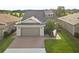Two-story home with attached garage and brick driveway at 5589 Nw 40Th Loop, Ocala, FL 34482