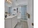 Clean bathroom with white vanity, tub, and shower at 675 Winterberry Trl, Deland, FL 32724
