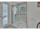 Updated bathroom with marble shower, glass enclosure, and a window at 675 Winterberry Trl, Deland, FL 32724
