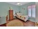 Charming bedroom with a twin bed and wood flooring at 675 Winterberry Trl, Deland, FL 32724