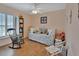 Bedroom with daybed, rocking chair, and wood floors at 675 Winterberry Trl, Deland, FL 32724