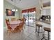 Charming dining area with wood table and chairs, offering views of the backyard at 675 Winterberry Trl, Deland, FL 32724