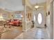 Elegant entryway with tiled flooring and a view of the living room at 675 Winterberry Trl, Deland, FL 32724