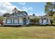 Inviting one-story home with blue accents and a well-manicured lawn at 675 Winterberry Trl, Deland, FL 32724