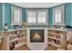 Cozy corner fireplace with built-in shelving and a tranquil ambiance at 675 Winterberry Trl, Deland, FL 32724