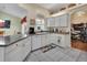 Well-equipped kitchen with white cabinets and granite countertops at 675 Winterberry Trl, Deland, FL 32724