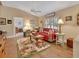 Cozy living room featuring a red couch and floral rug at 675 Winterberry Trl, Deland, FL 32724