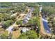 Aerial view of peaceful neighborhood with lake and lush trees at 675 Winterberry Trl, Deland, FL 32724