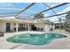 Relaxing kidney-shaped pool with a screened enclosure and patio at 675 Winterberry Trl, Deland, FL 32724