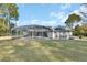 Screened pool and patio area with fire pit at 675 Winterberry Trl, Deland, FL 32724