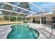 Inviting pool area with screened enclosure, patio, and lush landscaping at 675 Winterberry Trl, Deland, FL 32724