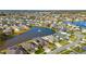 Aerial view of a house with a pool and a lake in a residential area at 6832 Forkmead Ln, Port Orange, FL 32128