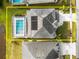 Aerial view of a house with a pool and solar panels on the roof at 6832 Forkmead Ln, Port Orange, FL 32128