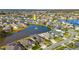 Aerial view of a house with a pool and a lake in a residential area at 6832 Forkmead Ln, Port Orange, FL 32128