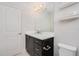 Bathroom with dark vanity, white countertop and a large mirror at 6832 Forkmead Ln, Port Orange, FL 32128