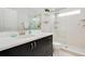 Clean bathroom with dark vanity, shower, and white tile at 6832 Forkmead Ln, Port Orange, FL 32128