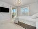 Bright and airy bedroom with a king-size bed, sliding glass doors to a patio, and a large TV at 6832 Forkmead Ln, Port Orange, FL 32128