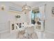 Bright breakfast nook with a round table and white chairs, adjacent to a sliding glass door at 6832 Forkmead Ln, Port Orange, FL 32128