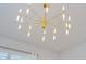 Modern gold chandelier with linear lights, ideal for a bedroom or dining room at 6832 Forkmead Ln, Port Orange, FL 32128