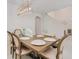 Spacious dining area with a large wooden table, bench seating, and stylish light fixture at 6832 Forkmead Ln, Port Orange, FL 32128