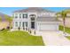 Stunning two-story home with a three-car garage and manicured lawn at 6832 Forkmead Ln, Port Orange, FL 32128
