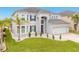 Two-story house with gray exterior, stone accents, and a three-car garage at 6832 Forkmead Ln, Port Orange, FL 32128