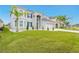 Two-story house with gray exterior, stone accents, and a three-car garage at 6832 Forkmead Ln, Port Orange, FL 32128