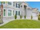 Two-story house with gray exterior, stone accents, and a three-car garage at 6832 Forkmead Ln, Port Orange, FL 32128