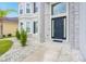 Dark blue front door with stone accents and a decorative chandelier at 6832 Forkmead Ln, Port Orange, FL 32128