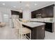 Updated kitchen boasts dark wood cabinets, a large island with seating, and stainless steel appliances at 6832 Forkmead Ln, Port Orange, FL 32128