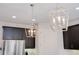 Kitchen features stylish light fixtures above the island and dark wood cabinets at 6832 Forkmead Ln, Port Orange, FL 32128
