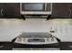 Stainless steel stove top and microwave in modern kitchen at 6832 Forkmead Ln, Port Orange, FL 32128