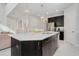 Modern kitchen with a large island, dark cabinets, and white quartz countertops at 6832 Forkmead Ln, Port Orange, FL 32128