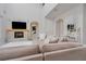 Living room features a cozy sectional sofa and a stone fireplace with a wood mantel at 6832 Forkmead Ln, Port Orange, FL 32128
