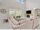 Spacious living room boasts a large sectional sofa, fireplace, and high ceilings at 6832 Forkmead Ln, Port Orange, FL 32128