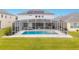 Inviting pool with a screened enclosure and adjacent patio at 6832 Forkmead Ln, Port Orange, FL 32128