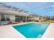 Inviting pool area with screened enclosure, providing ample space for relaxation and entertainment at 6832 Forkmead Ln, Port Orange, FL 32128