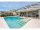 Sparkling pool with a fountain and a large screened enclosure at 6832 Forkmead Ln, Port Orange, FL 32128