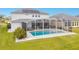 Relaxing pool area with a screened enclosure and solar panels at 6832 Forkmead Ln, Port Orange, FL 32128