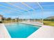 Relaxing pool with screened enclosure overlooking a serene lake at 6832 Forkmead Ln, Port Orange, FL 32128
