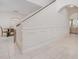 Elegant staircase with white railings and wainscoting at 6832 Forkmead Ln, Port Orange, FL 32128